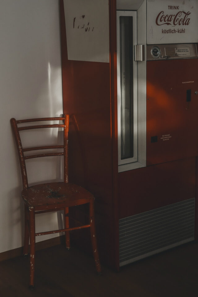 Roter Sessel und antiker Automat.